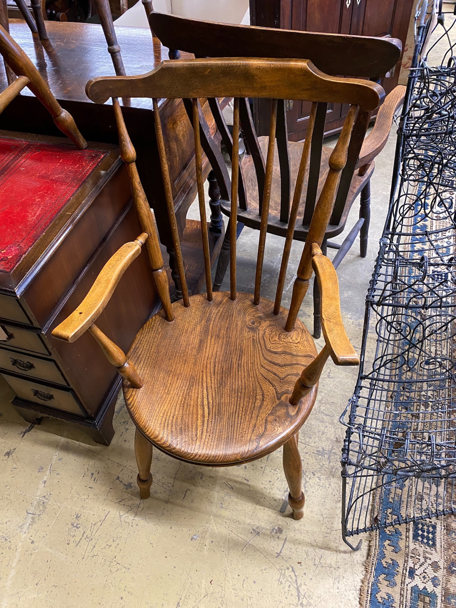 An early 20th century harlequin set of six Windsor elm and beech dining chairs, two with arms